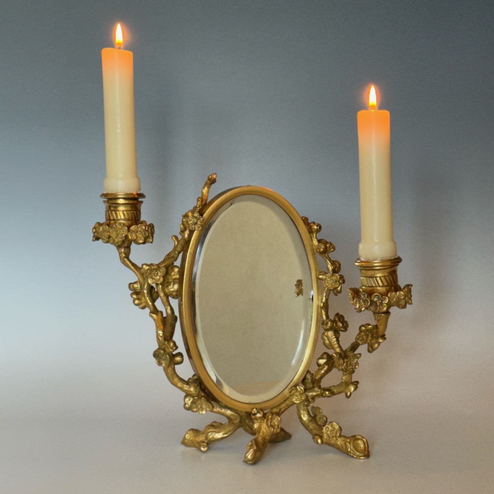 A French 19th-century gilt bronze table frame featuring a central oval classical relief medallion flanked by two candelabra arms with organic floral branching. View XI
