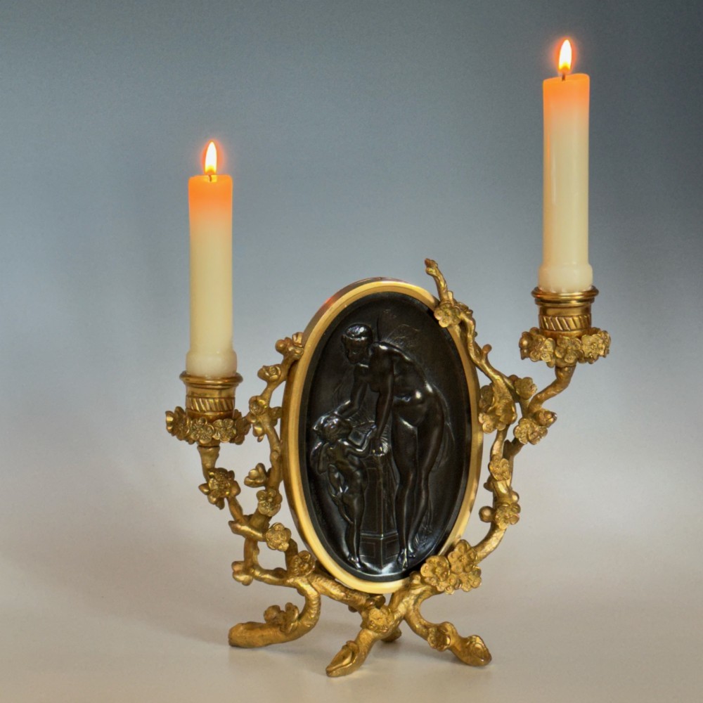 A French 19th-century gilt bronze table frame featuring a central oval classical relief medallion flanked by two candelabra arms with organic floral branching. View XII
