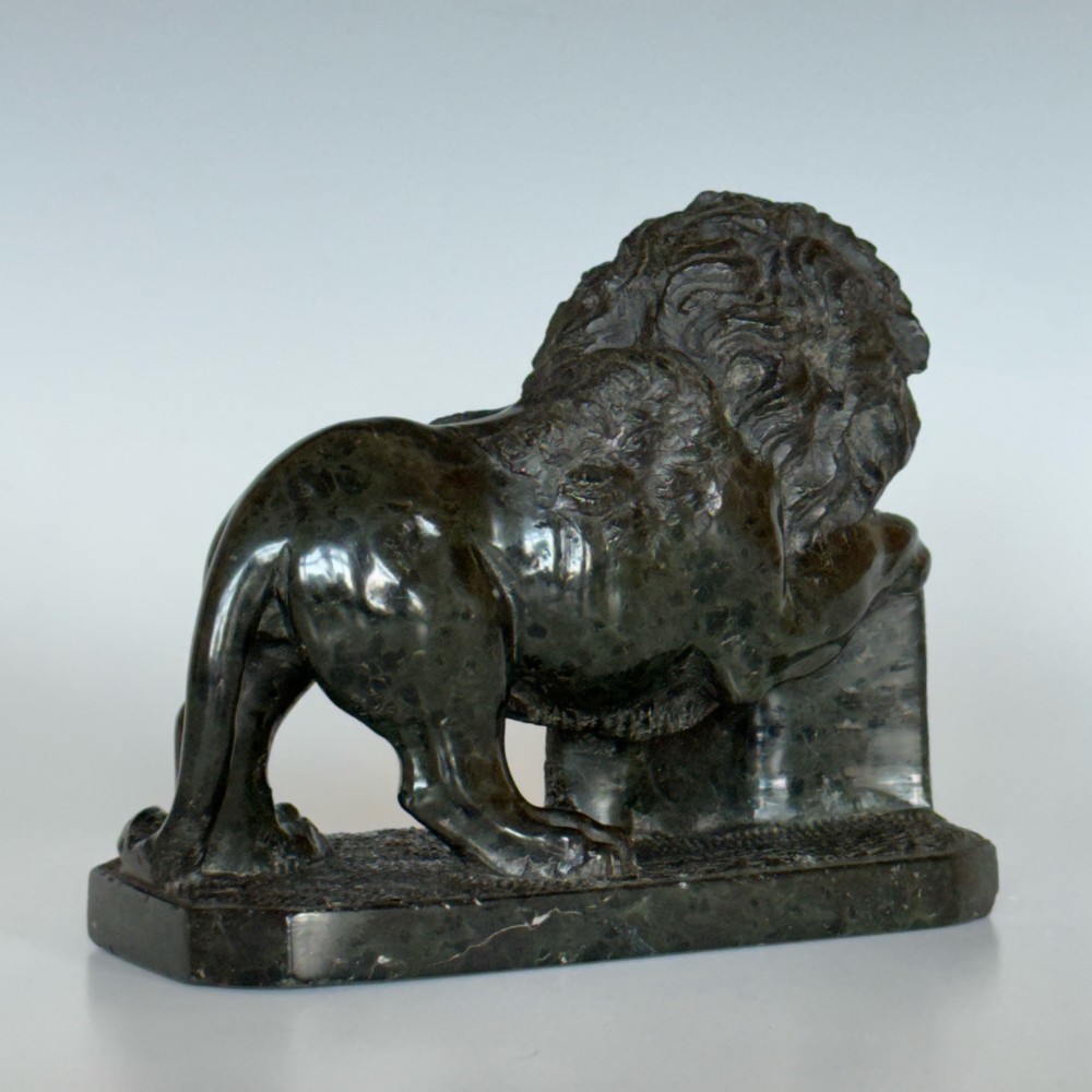 A dark green carved serpentine marble sculpture depicting the Lion of Saint Mark resting a paw on an upright book. View III
