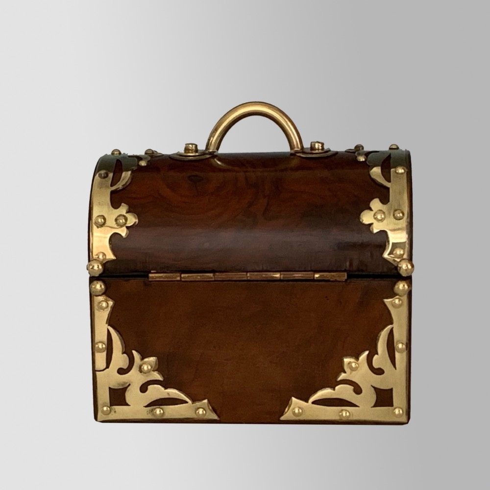 An open Victorian burr walnut scent casket with brass corner mounts containing two cut glass perfume bottles lined with blue fabric. View VIII