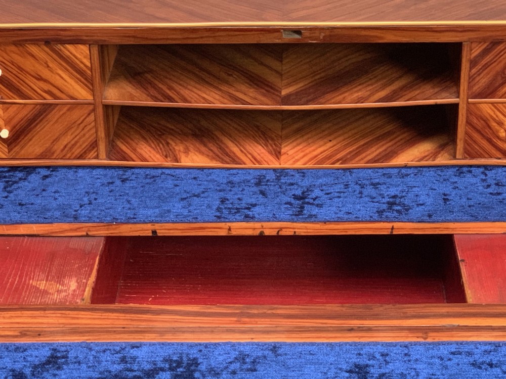 A 19th-century French Napoleon III tulipwood bureau featuring a slant top with brass inlay, ormolu mounts, and cabriole legs. View VI