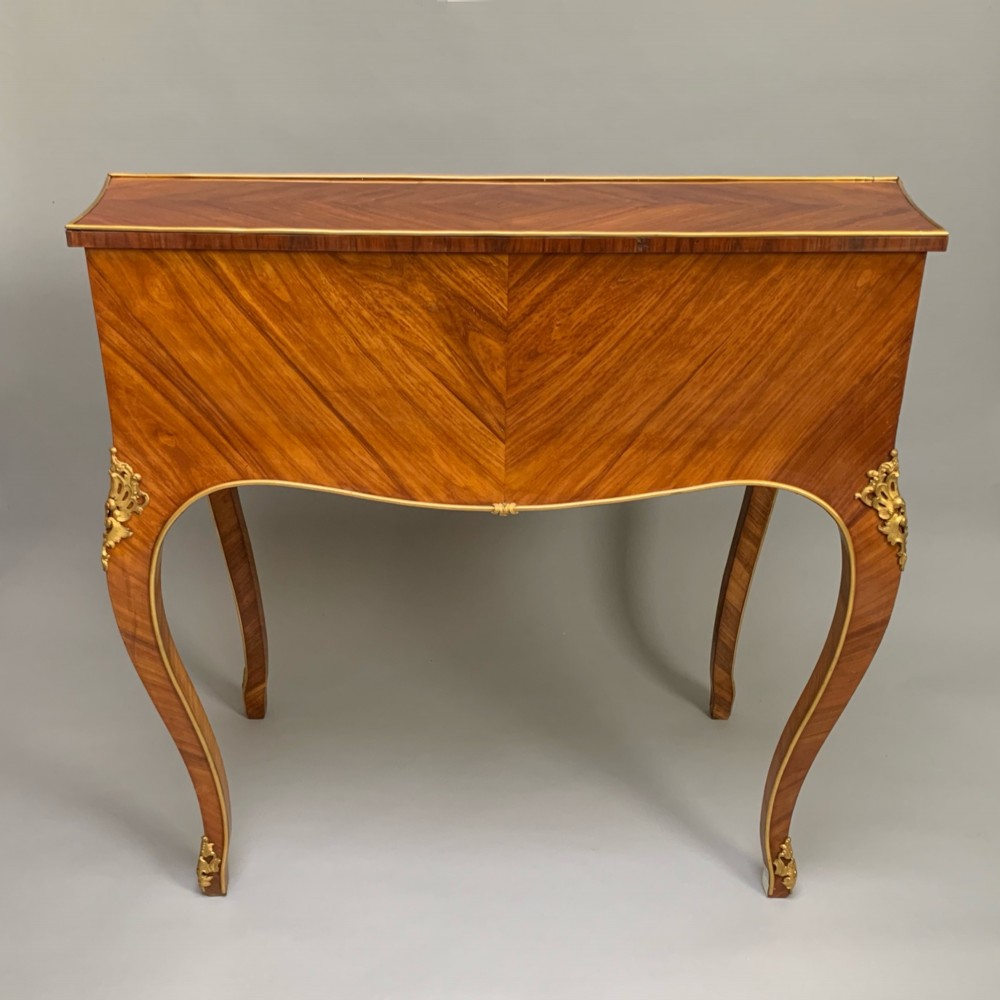 A 19th-century French Napoleon III tulipwood bureau featuring a slant top with brass inlay, ormolu mounts, and cabriole legs. View VII