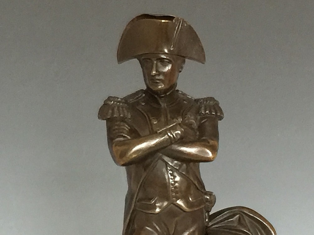 A nineteenth-century bronze figure of Napoleon Bonaparte in full military uniform standing with arms crossed on a yellow and grey marble plinth. View II