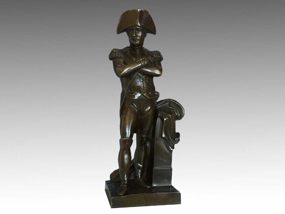 A nineteenth-century bronze figure of Napoleon Bonaparte in full military uniform standing with arms crossed on a yellow and grey marble plinth. View VIII