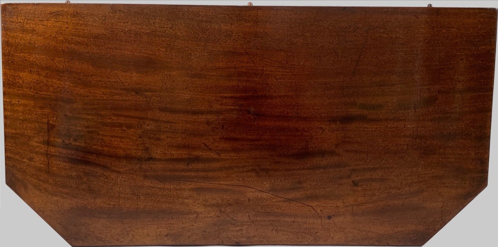 A George IV mahogany fold-over card table featuring a turned pedestal stem, geometric frieze inlay, and splayed legs with brass paw castors. View II
