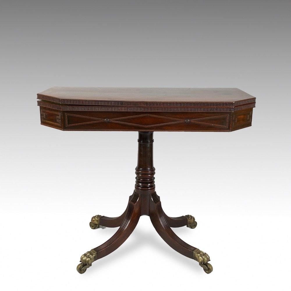 A George IV mahogany fold-over card table featuring a turned pedestal stem, geometric frieze inlay, and splayed legs with brass paw castors. View III