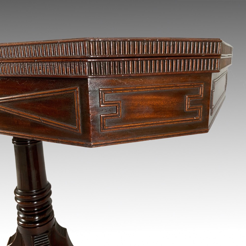 A George IV mahogany fold-over card table featuring a turned pedestal stem, geometric frieze inlay, and splayed legs with brass paw castors. View VI