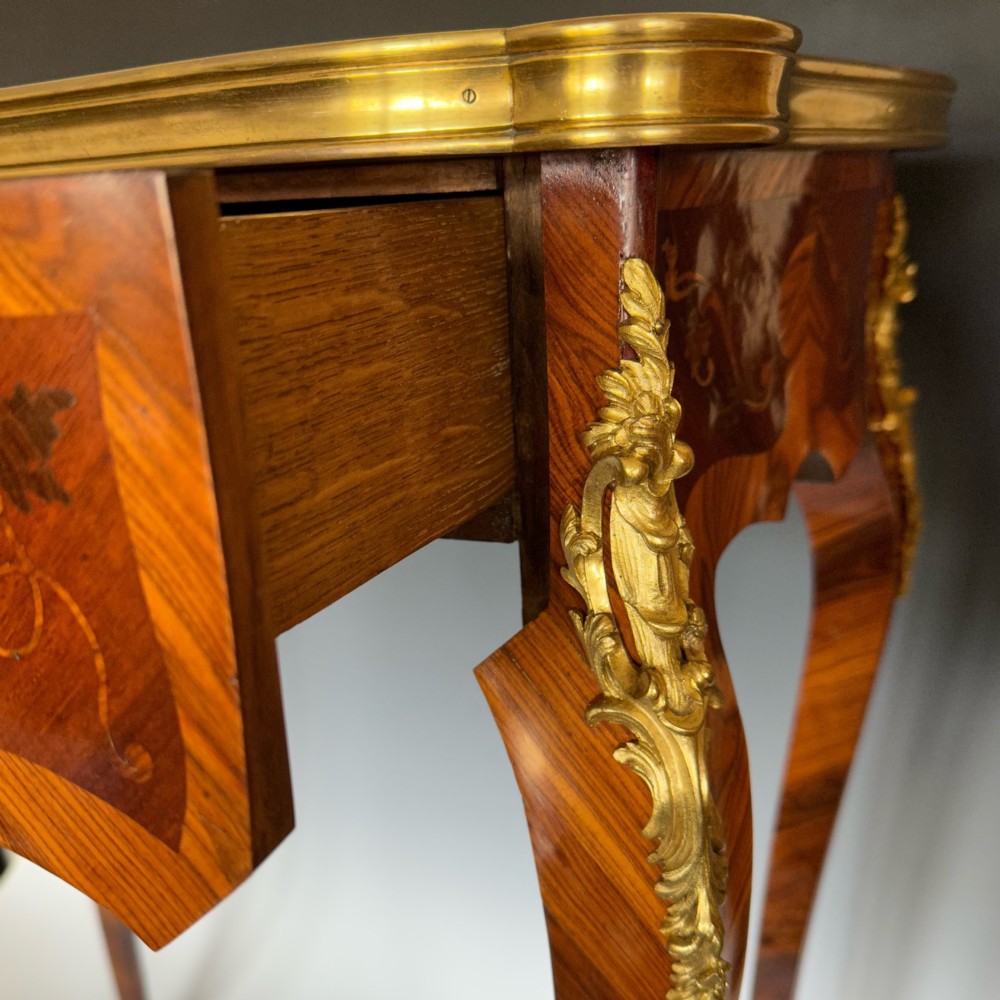 A French Louis XV style kingwood side table featuring floral marquetry inlay, slender cabriole legs, and ornate gilt bronze mounts. View IV