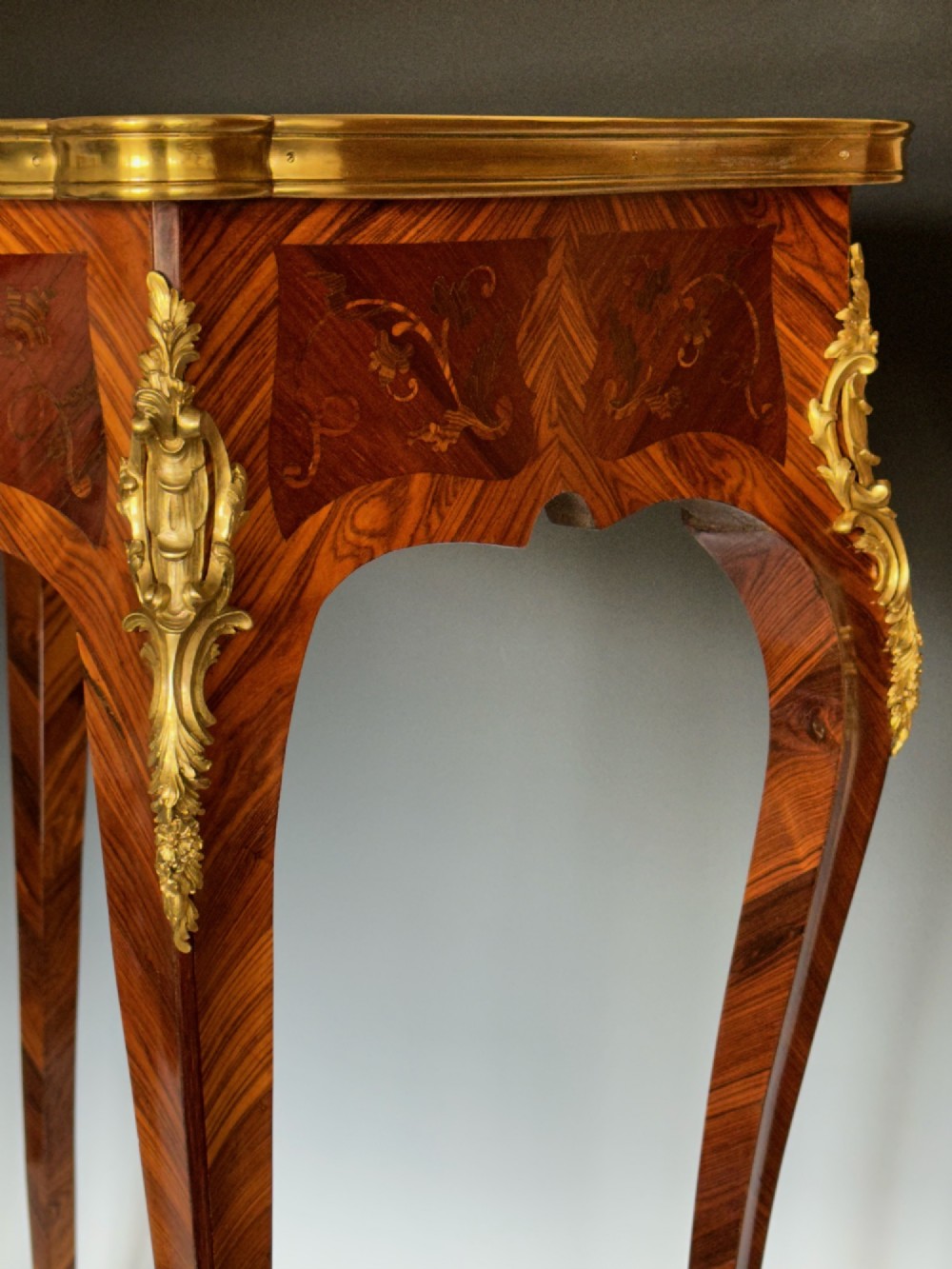 A French Louis XV style kingwood side table featuring floral marquetry inlay, slender cabriole legs, and ornate gilt bronze mounts. View VI