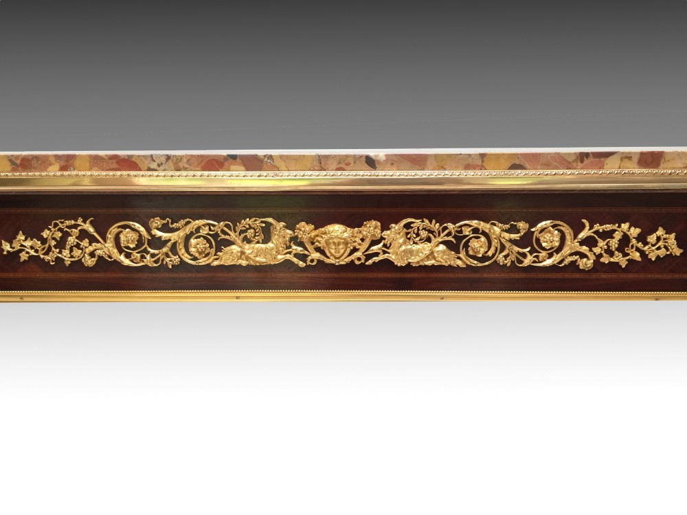 A rectangular Louis XVI style centre table featuring a variegated marble top, dark mahogany frieze with elaborate gilt bronze mounts, and four fluted tapered legs. View VI