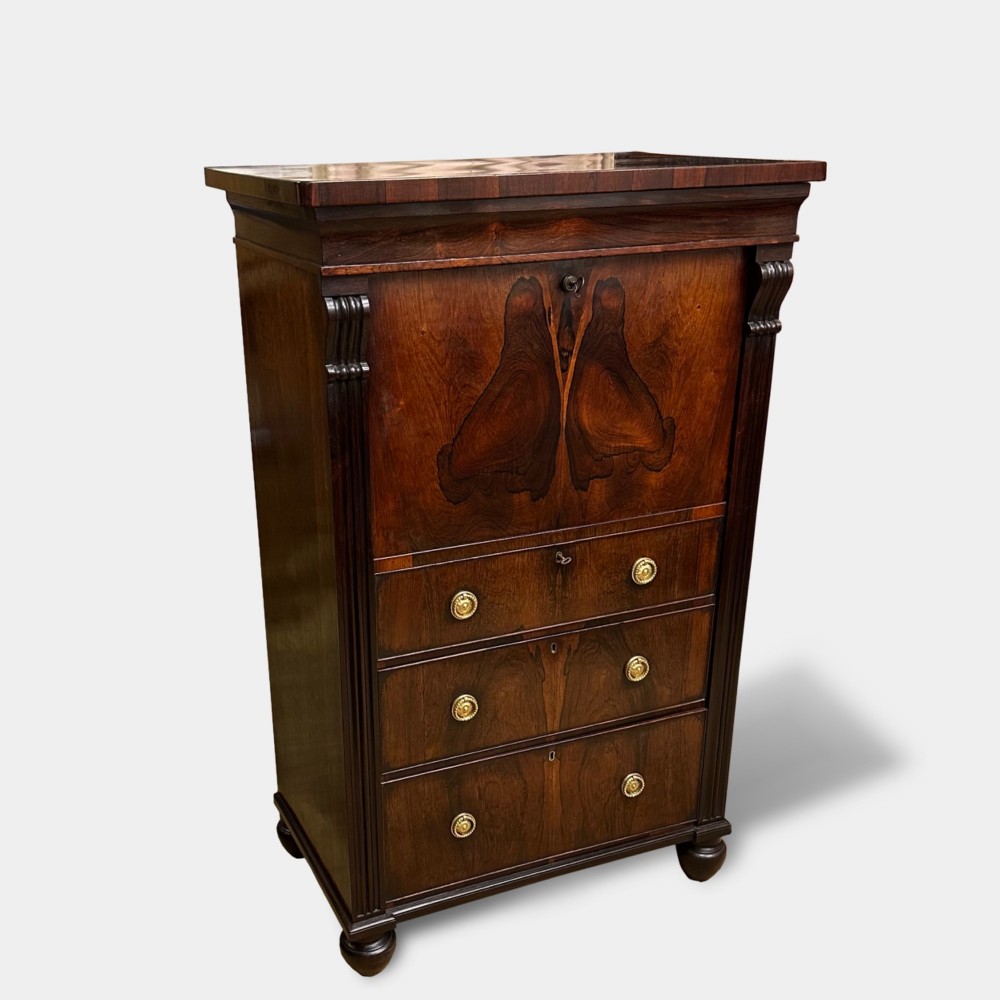 A George IV rosewood writing cabinet with a open fall-front desk revealing internal drawers and a dark green leather writing surface above lower drawers with brass handles. View II