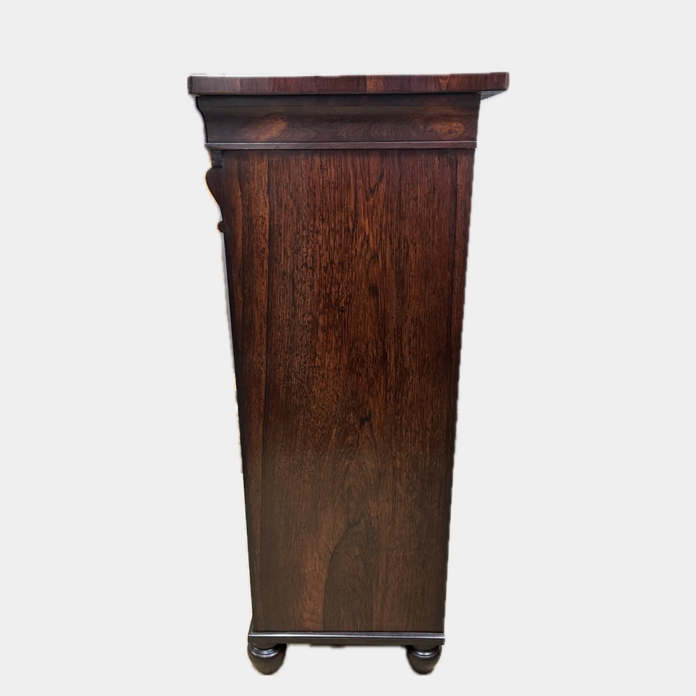A George IV rosewood writing cabinet with a open fall-front desk revealing internal drawers and a dark green leather writing surface above lower drawers with brass handles. View VIII