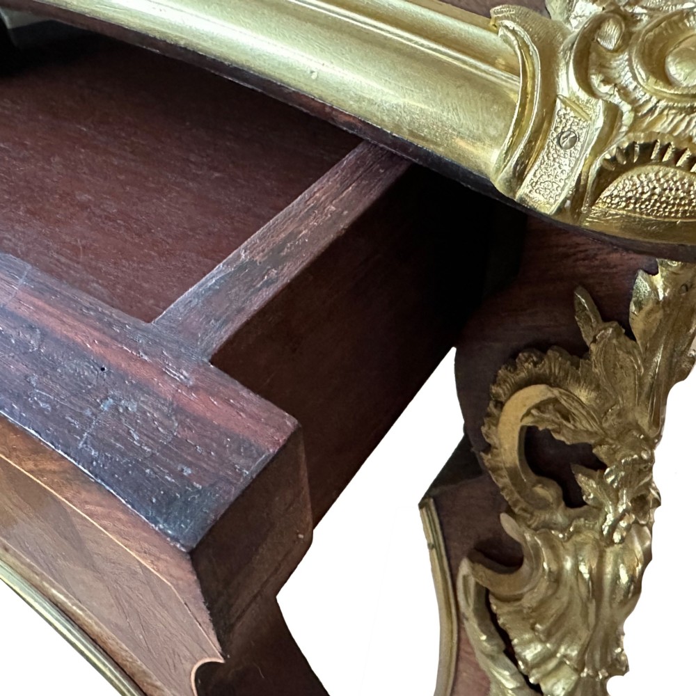 A French Louis XV style rosewood centre table featuring geometric parquetry, floral marquetry inlay, gilt-bronze ormolu mounts, and cabriole legs. View II