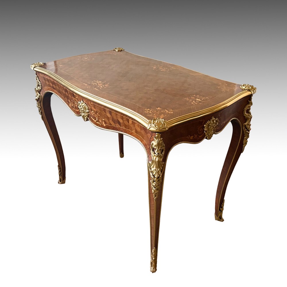 A French Louis XV style rosewood centre table featuring geometric parquetry, floral marquetry inlay, gilt-bronze ormolu mounts, and cabriole legs. View V