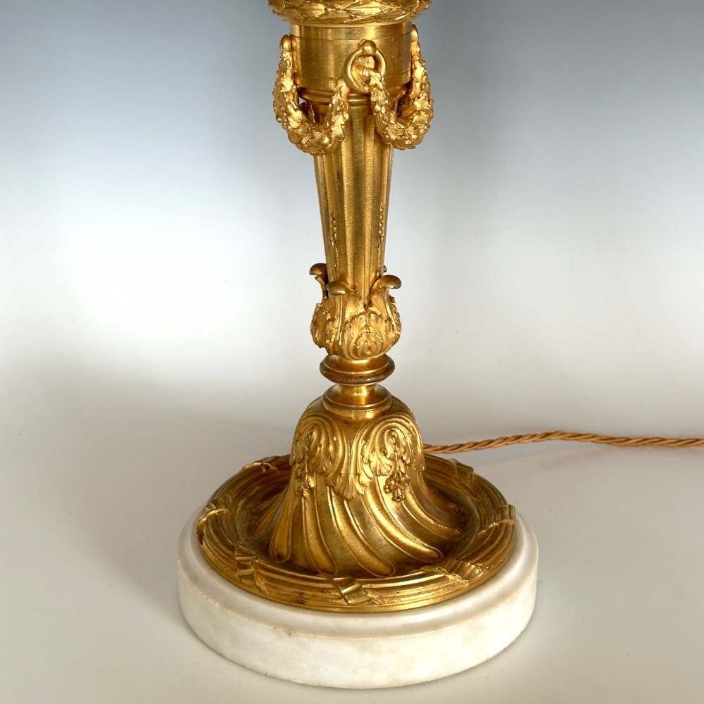 A Louis XV style gilt bronze ormolu table lamp featuring cast foliage swags, acanthus leaf detailing, and a circular white marble base. View III