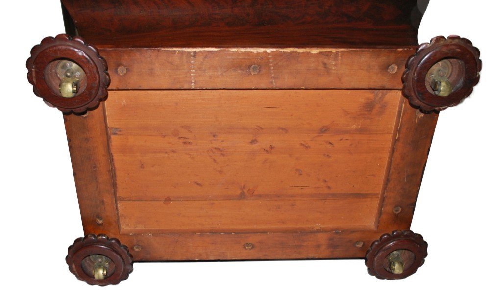 A George IV mahogany cellarette featuring a sarcophagus shape, stepped hinged lid, brass escutcheon, and carved lobed feet. View II