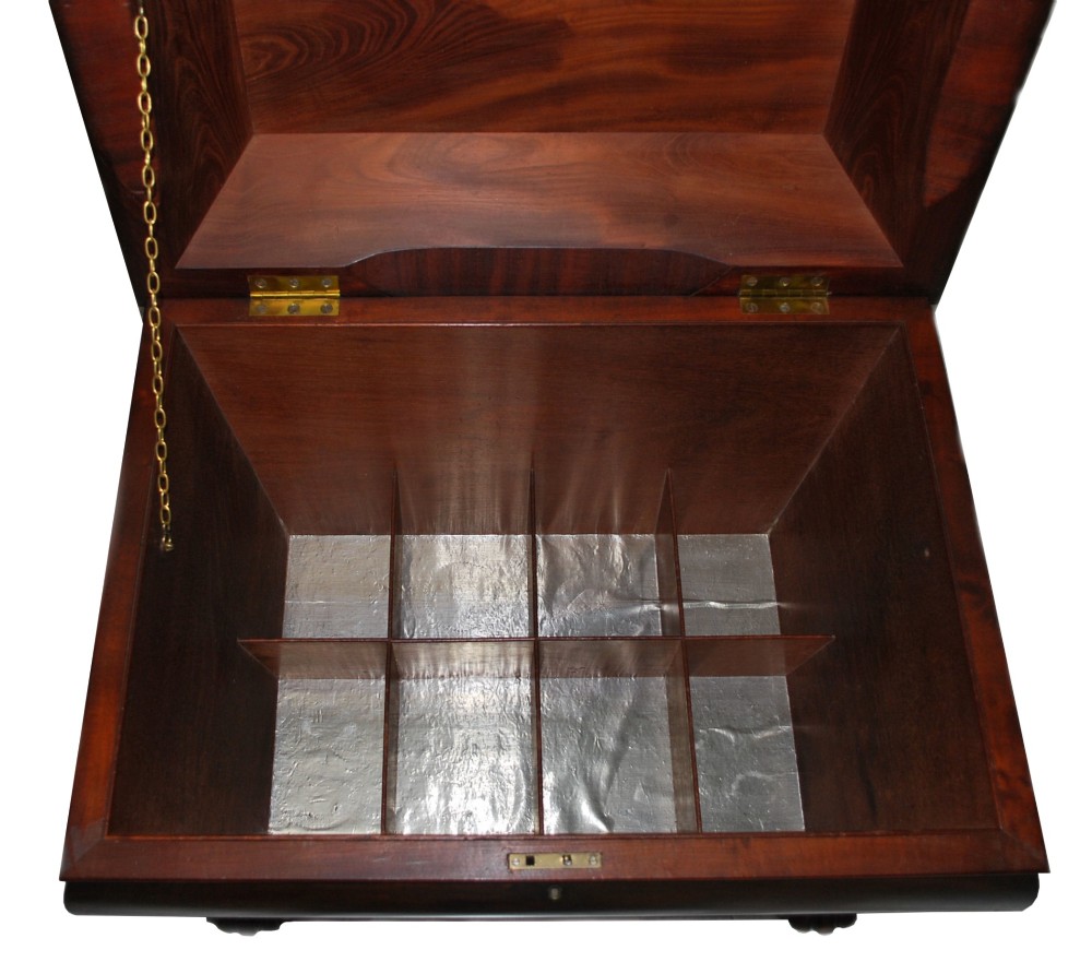 A George IV mahogany cellarette featuring a sarcophagus shape, stepped hinged lid, brass escutcheon, and carved lobed feet. View III