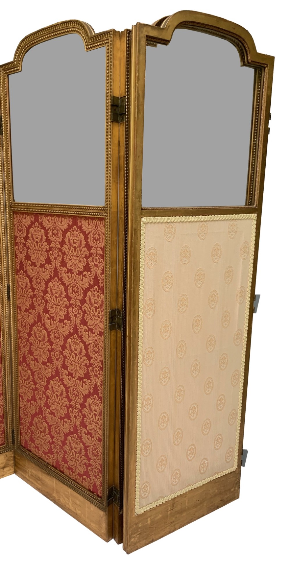 A Victorian four-fold screen featuring carved giltwood frames with arched tops, upper neutral panels, lower red and gold damask fabric panels, and brass hinges. View IV