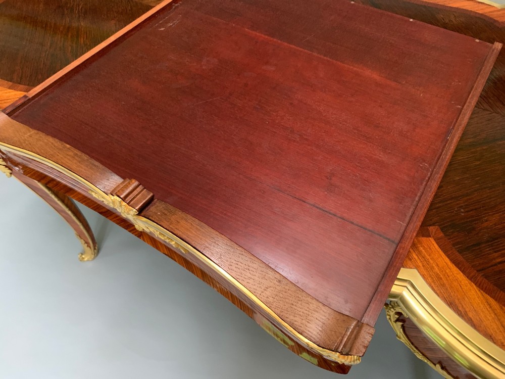 A French Louis XV style kingwood and rosewood centre table featuring serpentine edges, cabriole legs, and gilt-bronze mounts with female bust caryatids. View IV