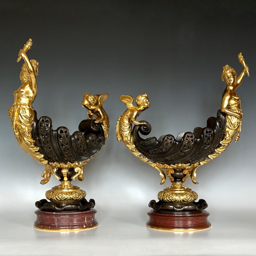 A pair of antique French gilt and patinated bronze centrepiece bowls mounted on red marble bases, decorated with sculpted cherubs and female figures holding torches. View II