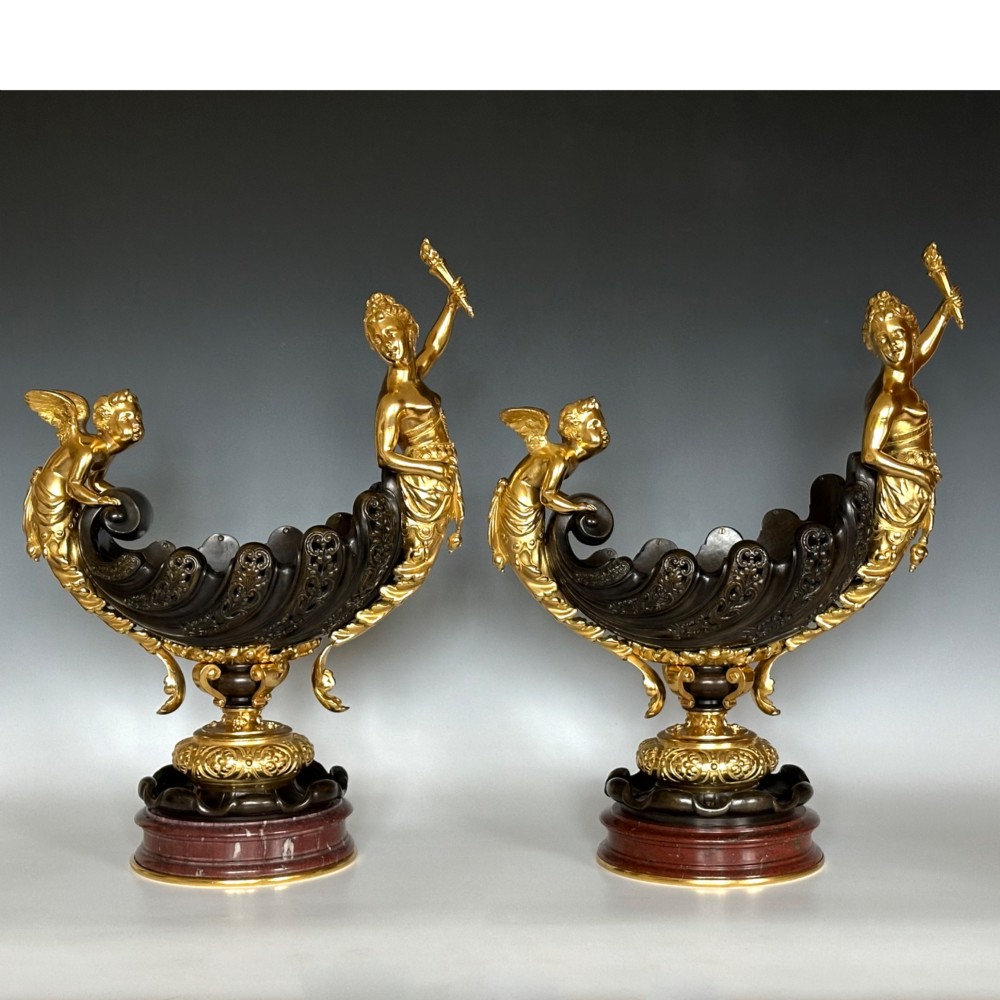 A pair of antique French gilt and patinated bronze centrepiece bowls mounted on red marble bases, decorated with sculpted cherubs and female figures holding torches. View VIII