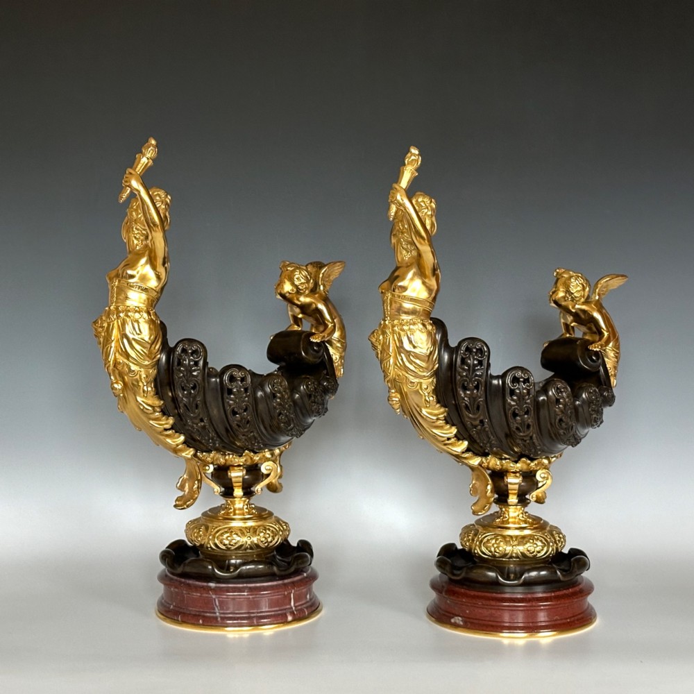 A pair of antique French gilt and patinated bronze centrepiece bowls mounted on red marble bases, decorated with sculpted cherubs and female figures holding torches. View IX