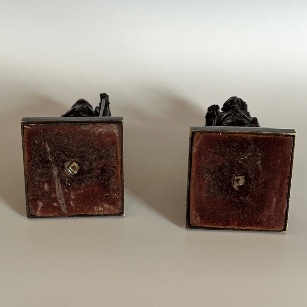 A pair of 19th-century French Restauration period patinated bronze statues of Voltaire and Rousseau mounted on yellow marble bases. View XI