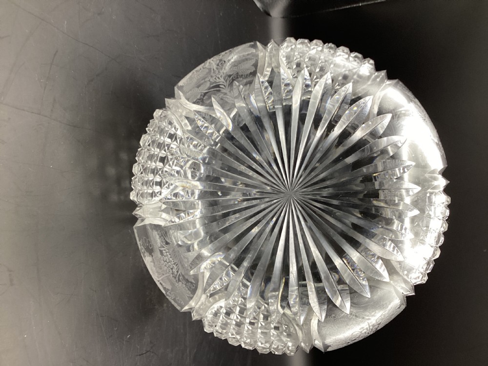 A Victorian clear cut glass sherry decanter with a bulbous body featuring geometric cuts, etched botanical motifs, a slender neck, and a faceted stopper. View V