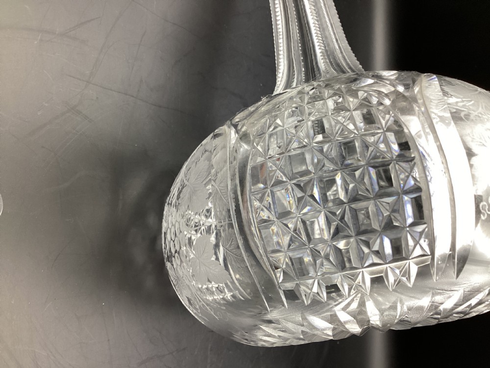 A Victorian clear cut glass sherry decanter with a bulbous body featuring geometric cuts, etched botanical motifs, a slender neck, and a faceted stopper. View VI