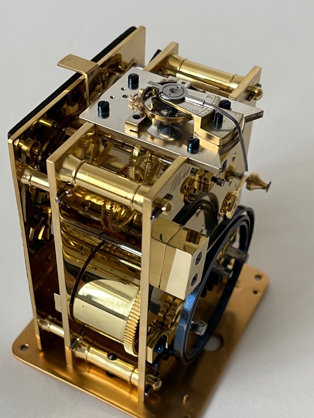 A rectangular gilt brass French repeating carriage clock with a top handle, glass side panels, and a white enamel dial with black Roman numerals. View VIII