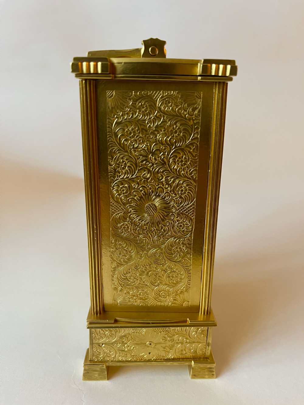 An engraved gilt brass Victorian English fusee carriage clock featuring Roman numerals and a folding carrying handle. View III