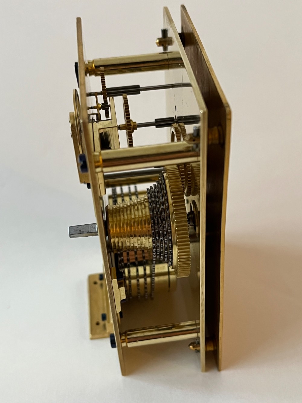 An engraved gilt brass Victorian English fusee carriage clock featuring Roman numerals and a folding carrying handle. View X