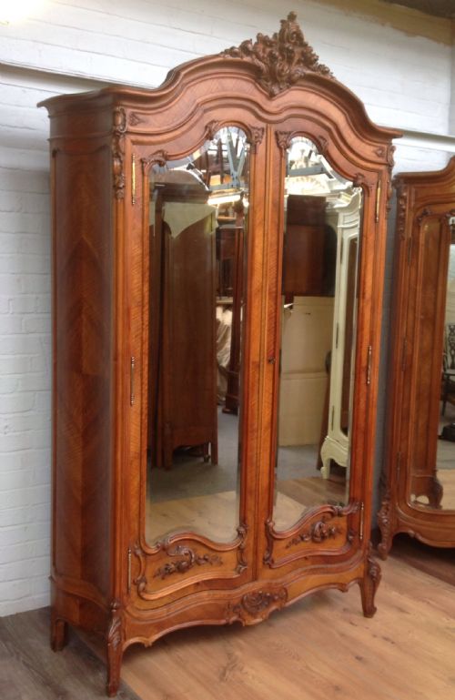 Antique French Walnut Armoire with Carved Doors.