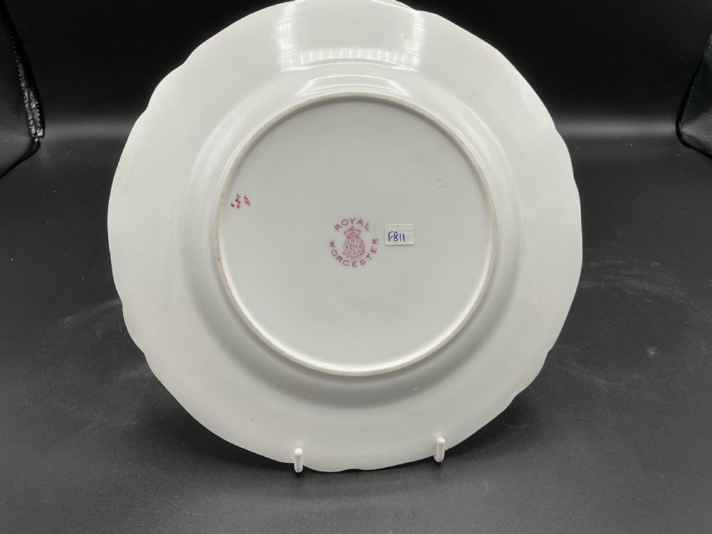 A circular hand-painted Royal Worcester porcelain cabinet plate depicting peaches and grapes with a gilded shaped rim. View II