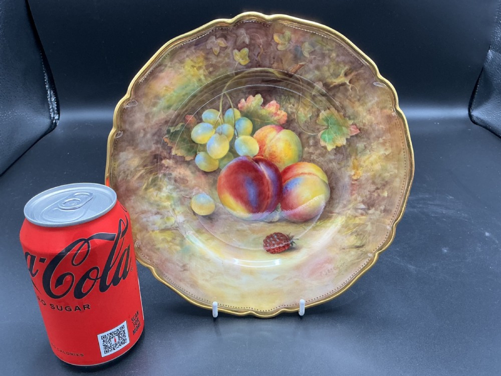 A circular hand-painted Royal Worcester porcelain cabinet plate depicting peaches and grapes with a gilded shaped rim. View III