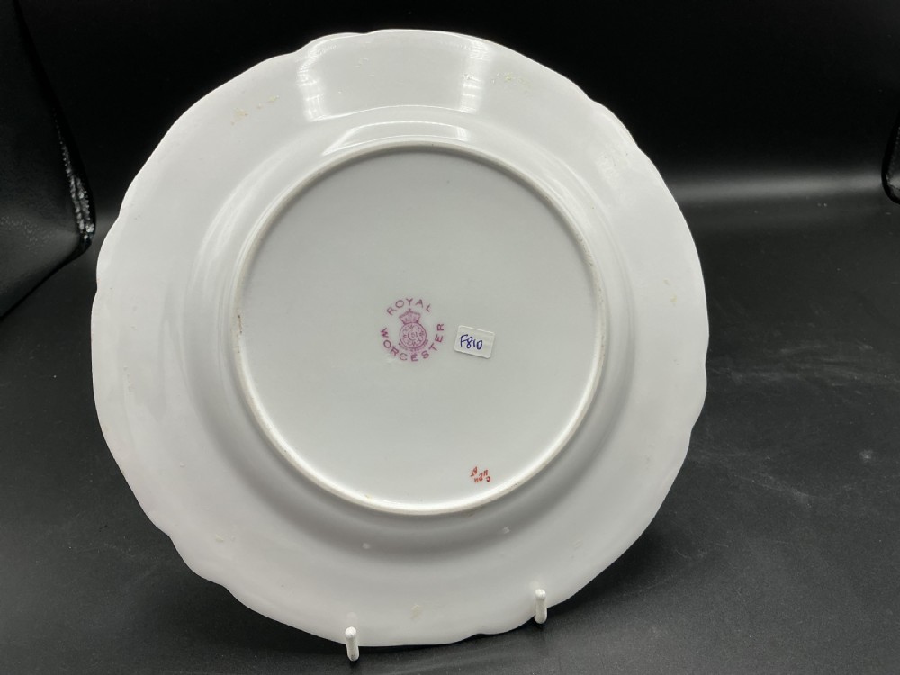 A circular bone china cabinet plate hand-painted with peaches and grapes against a mossy background, featuring a scalloped gilt rim. View II