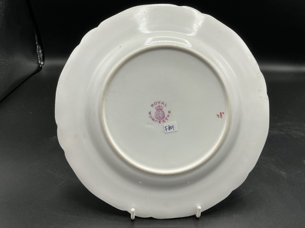 A circular Royal Worcester porcelain cabinet plate with a scalloped gilded rim, featuring a hand-painted still life of plums, raspberries, and gooseberries against a soft background. View II