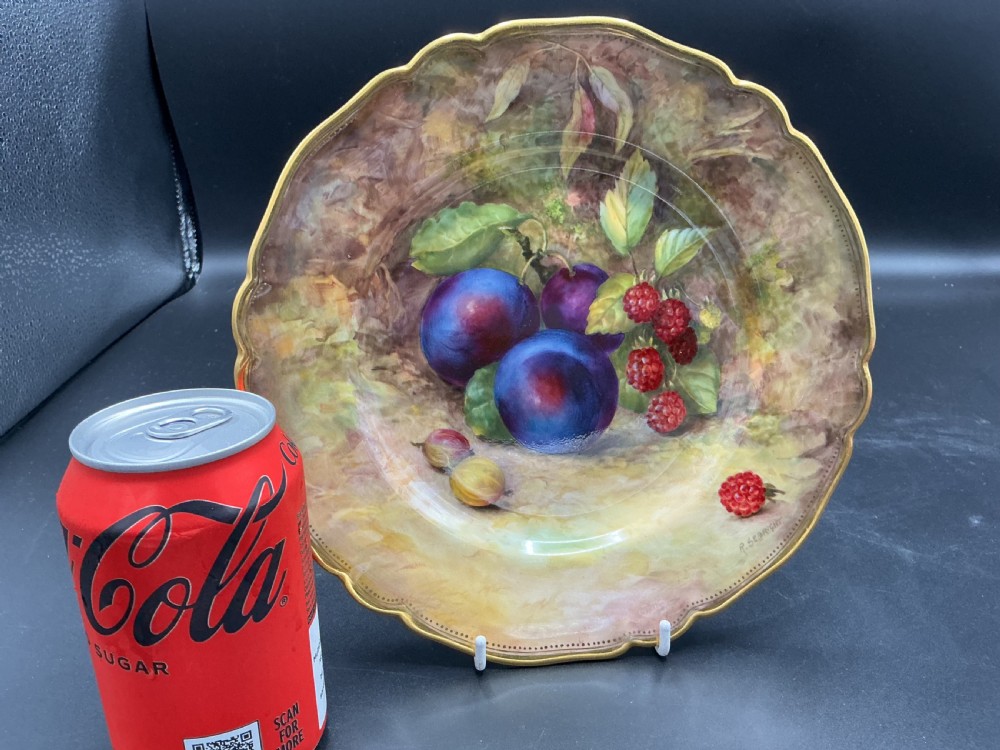 A circular Royal Worcester porcelain cabinet plate with a scalloped gilded rim, featuring a hand-painted still life of plums, raspberries, and gooseberries against a soft background. View III