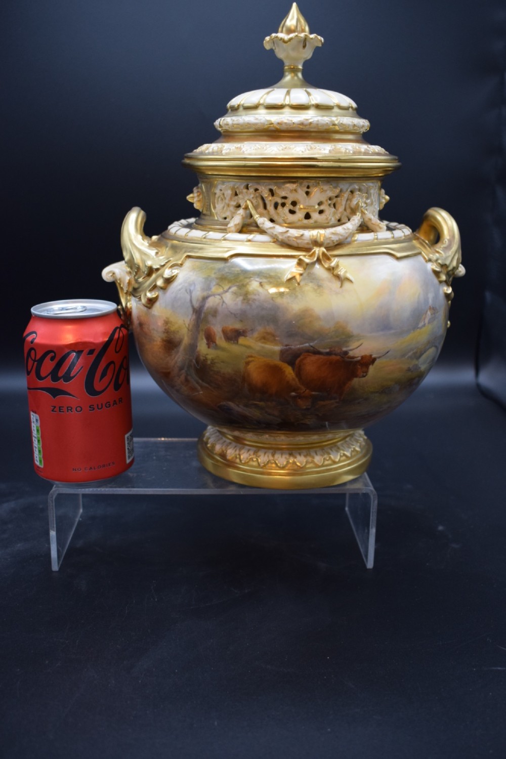 A gilded porcelain pot pourri vase with a pierced cover, twin scroll handles, and a painted landscape featuring Highland cattle. View III