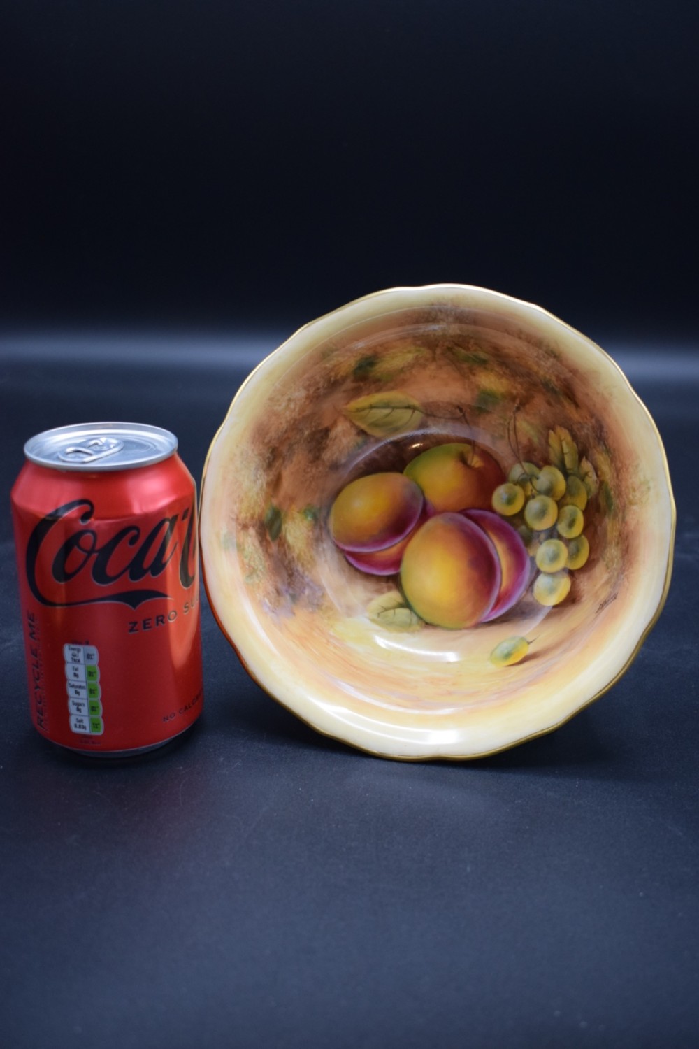 A pair of circular porcelain bowls featuring hand-painted peaches and grapes with gilded rims. View IV