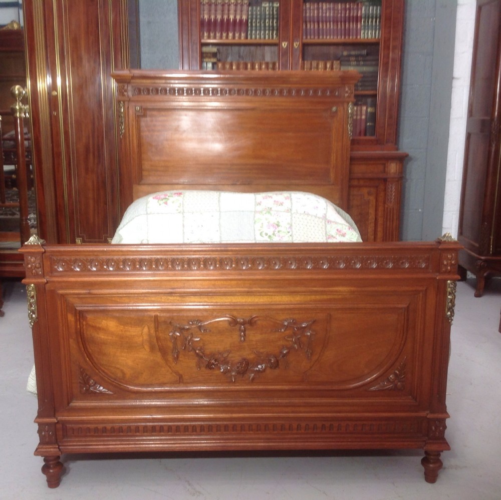 CARVED WALNUT FRENCH BED WITH BRASS DETAILING. View X