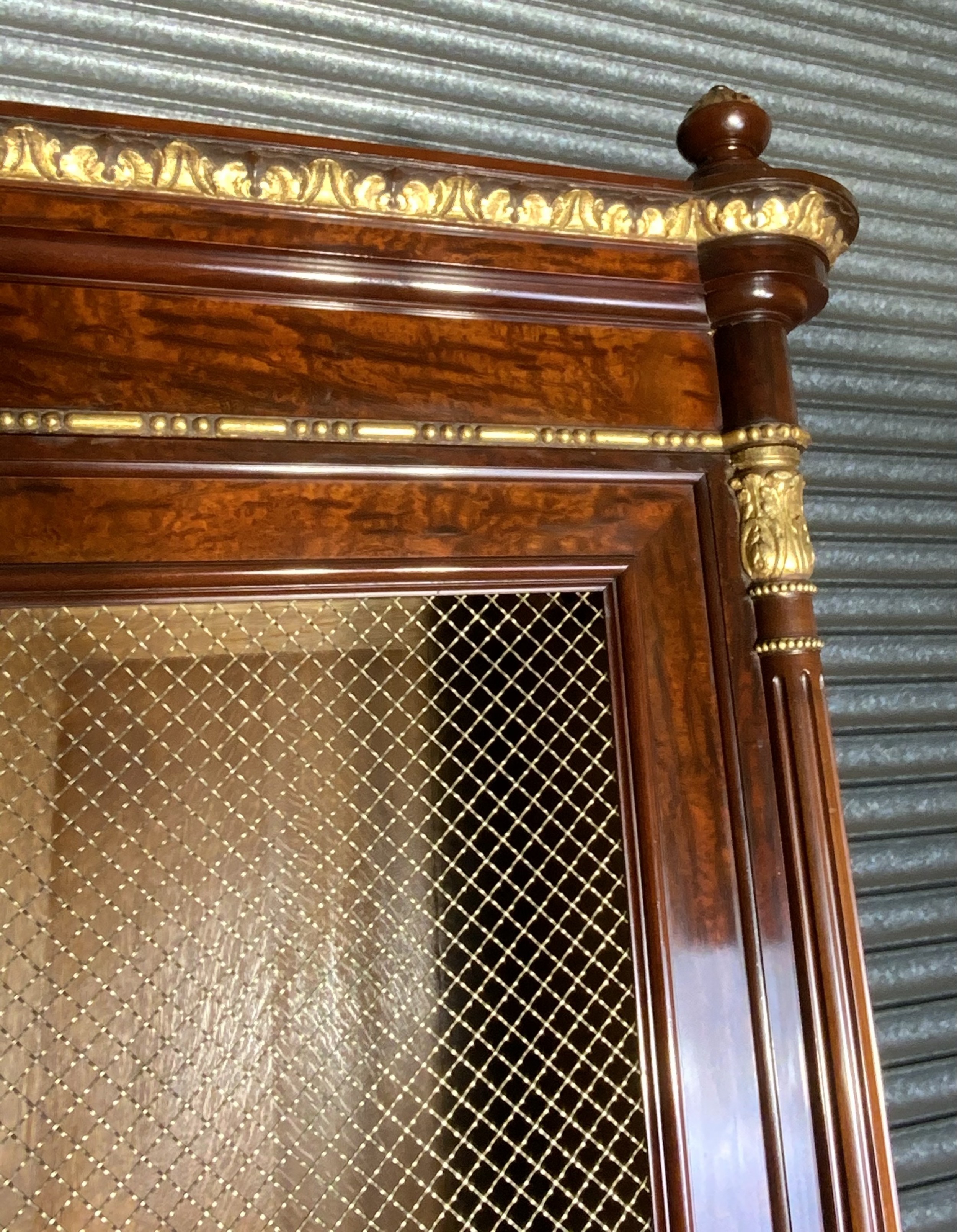 A large mahogany three-door armoire featuring a central arched mirrored door, wire-mesh side panels, and gilt bronze mounts. View IV
