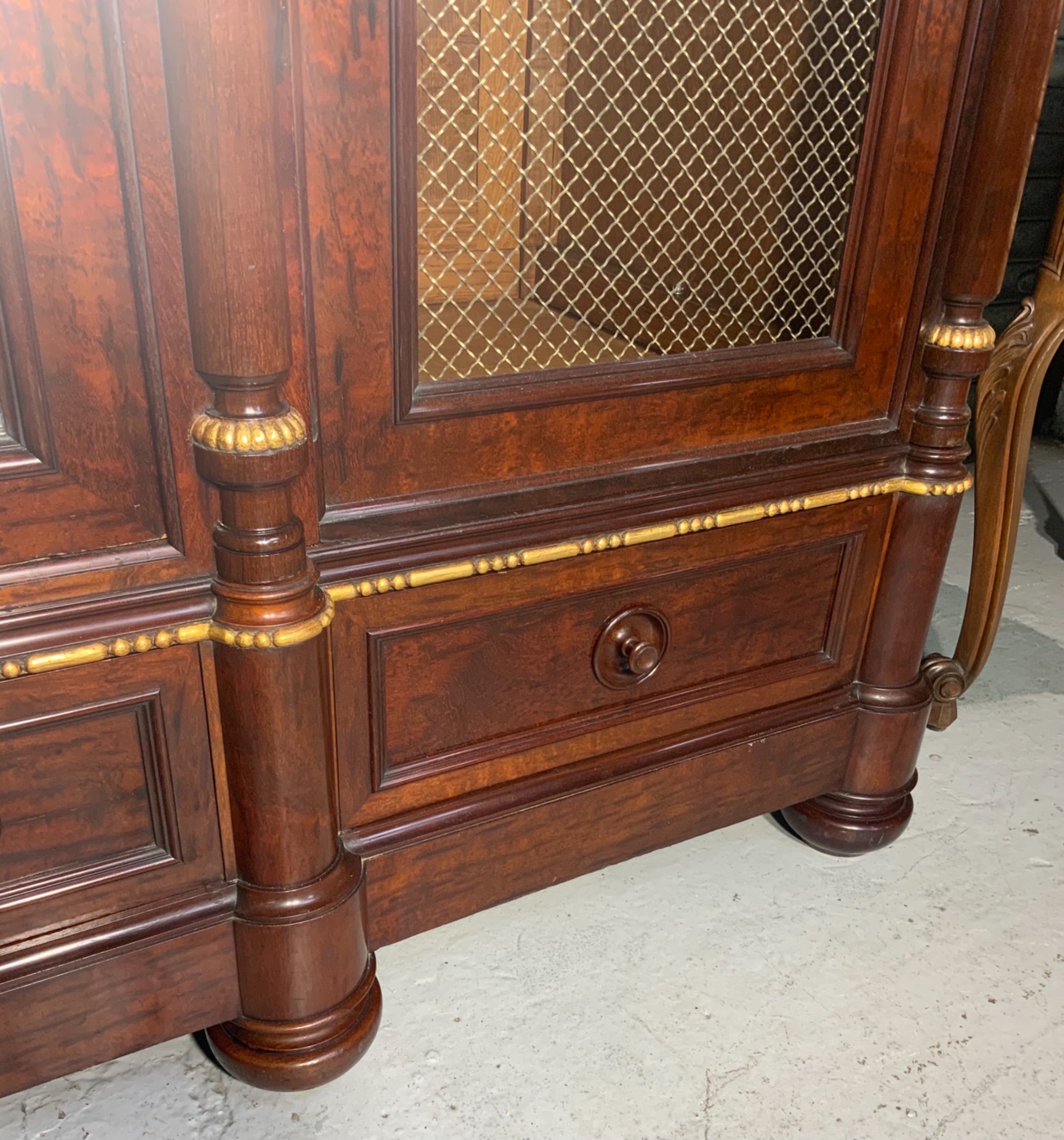 A large mahogany three-door armoire featuring a central arched mirrored door, wire-mesh side panels, and gilt bronze mounts. View XIV