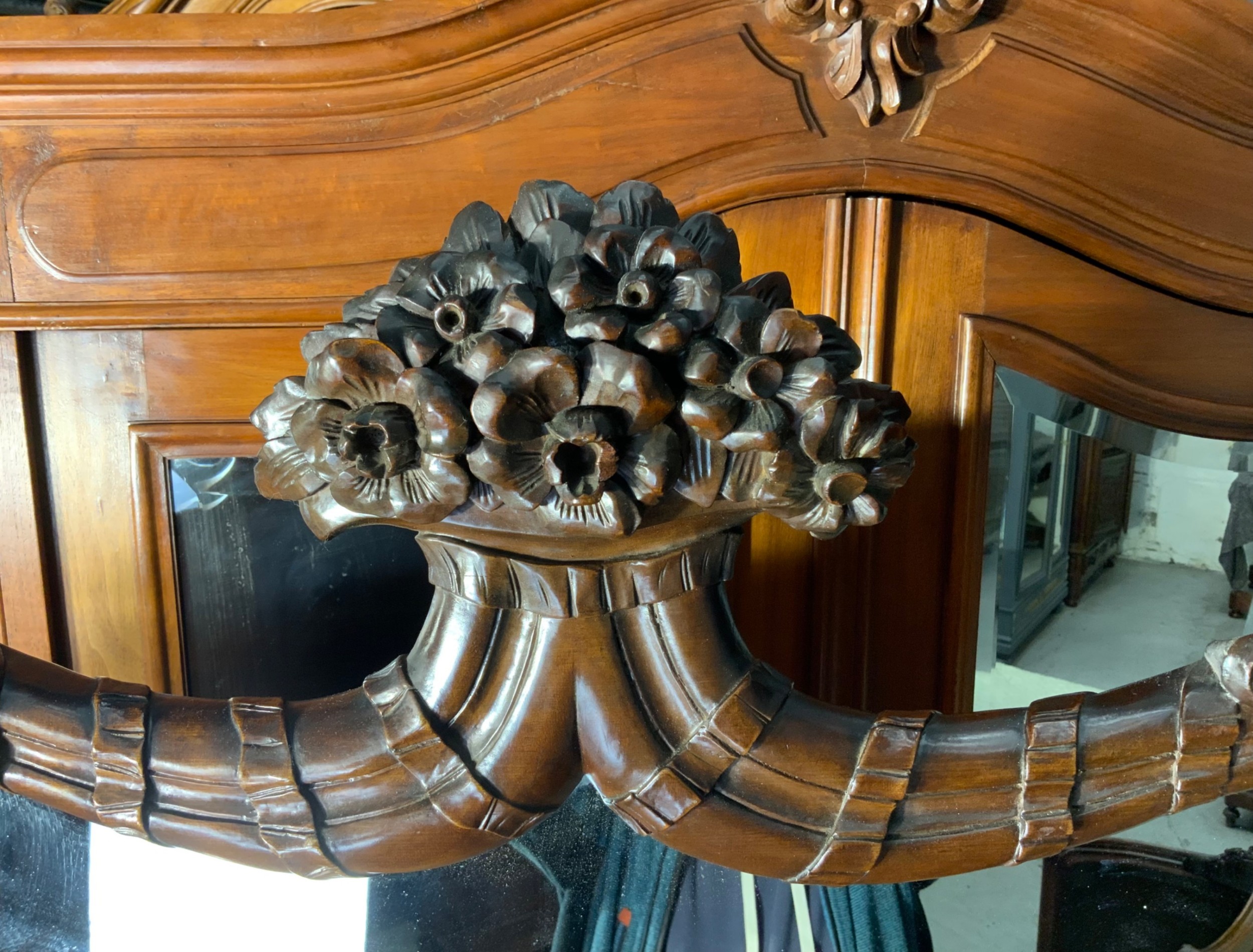 An early nineteenth-century Dutch mahogany dressing chest featuring detailed floral marquetry, three wide drawers, carved pilasters ending in paw feet, and an attached arched mirror. View VII