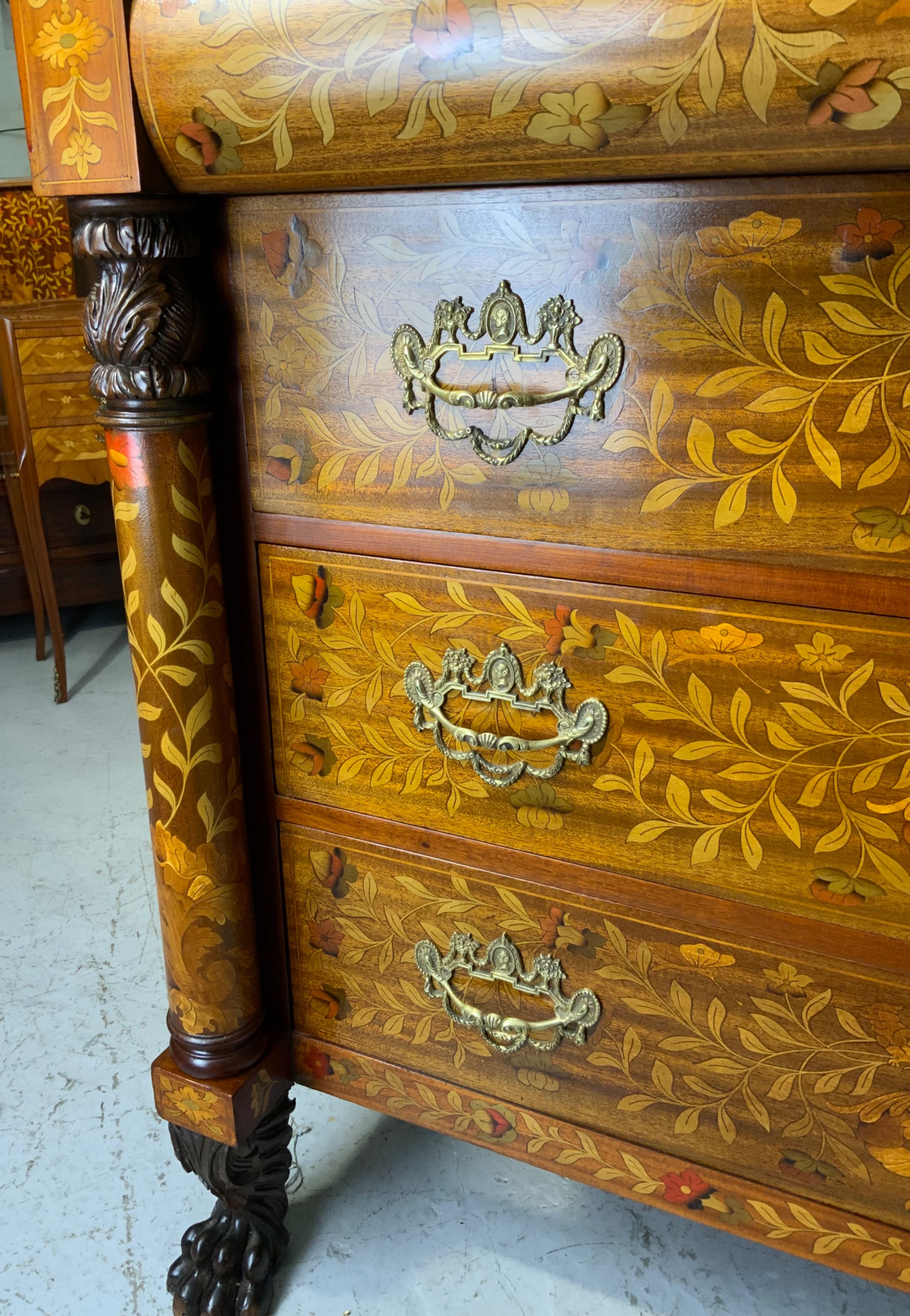An early nineteenth-century Dutch mahogany dressing chest featuring detailed floral marquetry, three wide drawers, carved pilasters ending in paw feet, and an attached arched mirror. View XV
