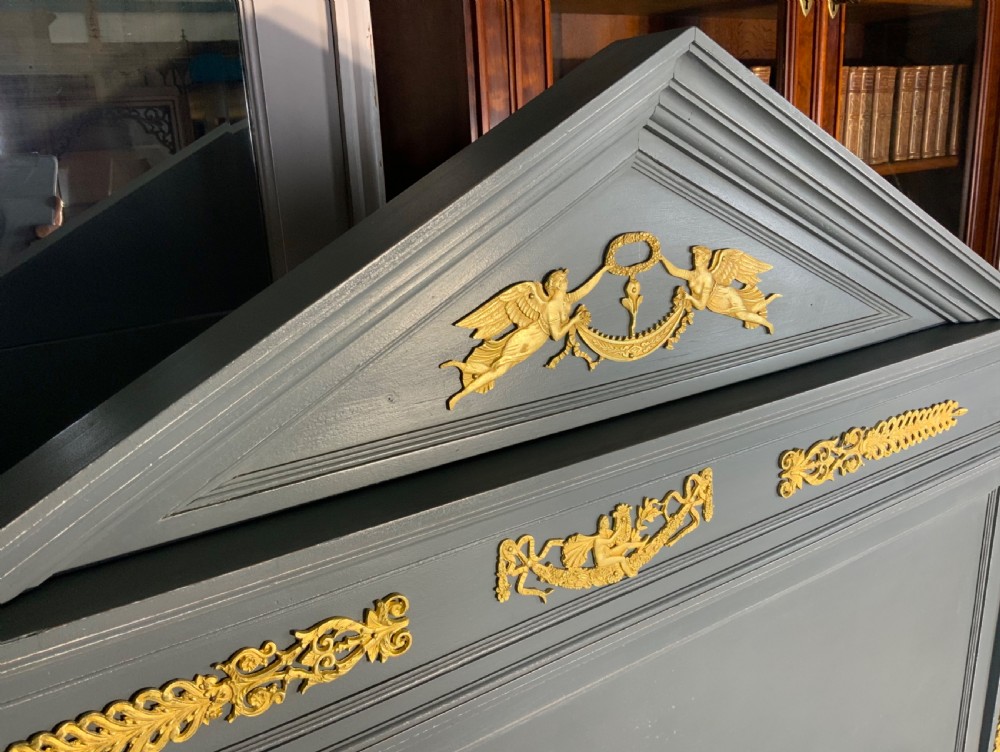 A grey painted French double bed frame decorated with gold brass mounts, featuring a central laurel wreath motif and a pediment headboard. View VIII