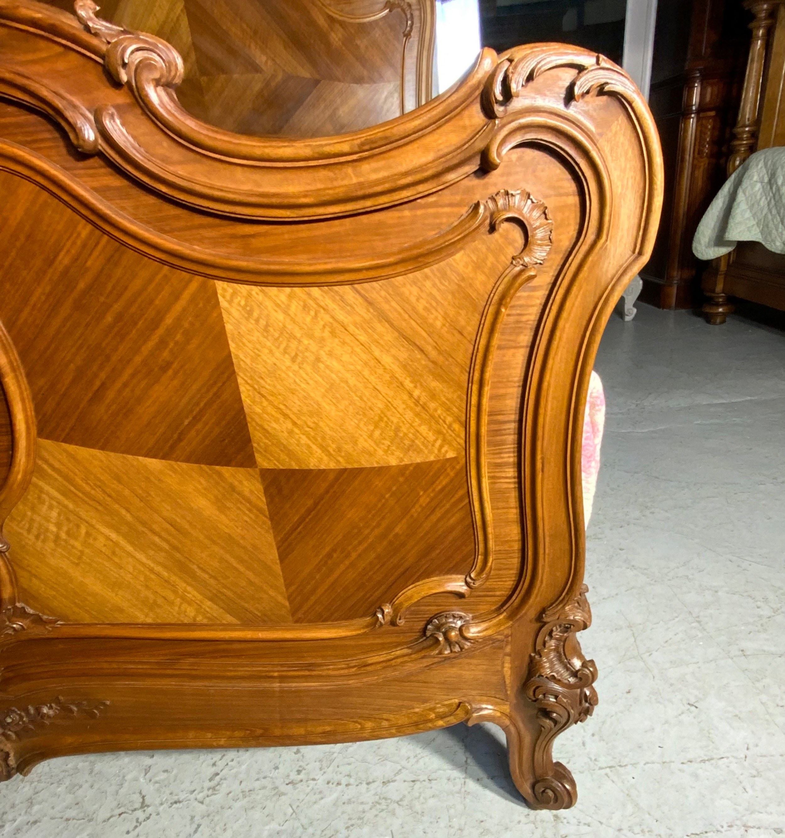 A king size French Louis XV style wooden bed frame featuring a carved crest, parquetry panelwork, and curved legs. View V