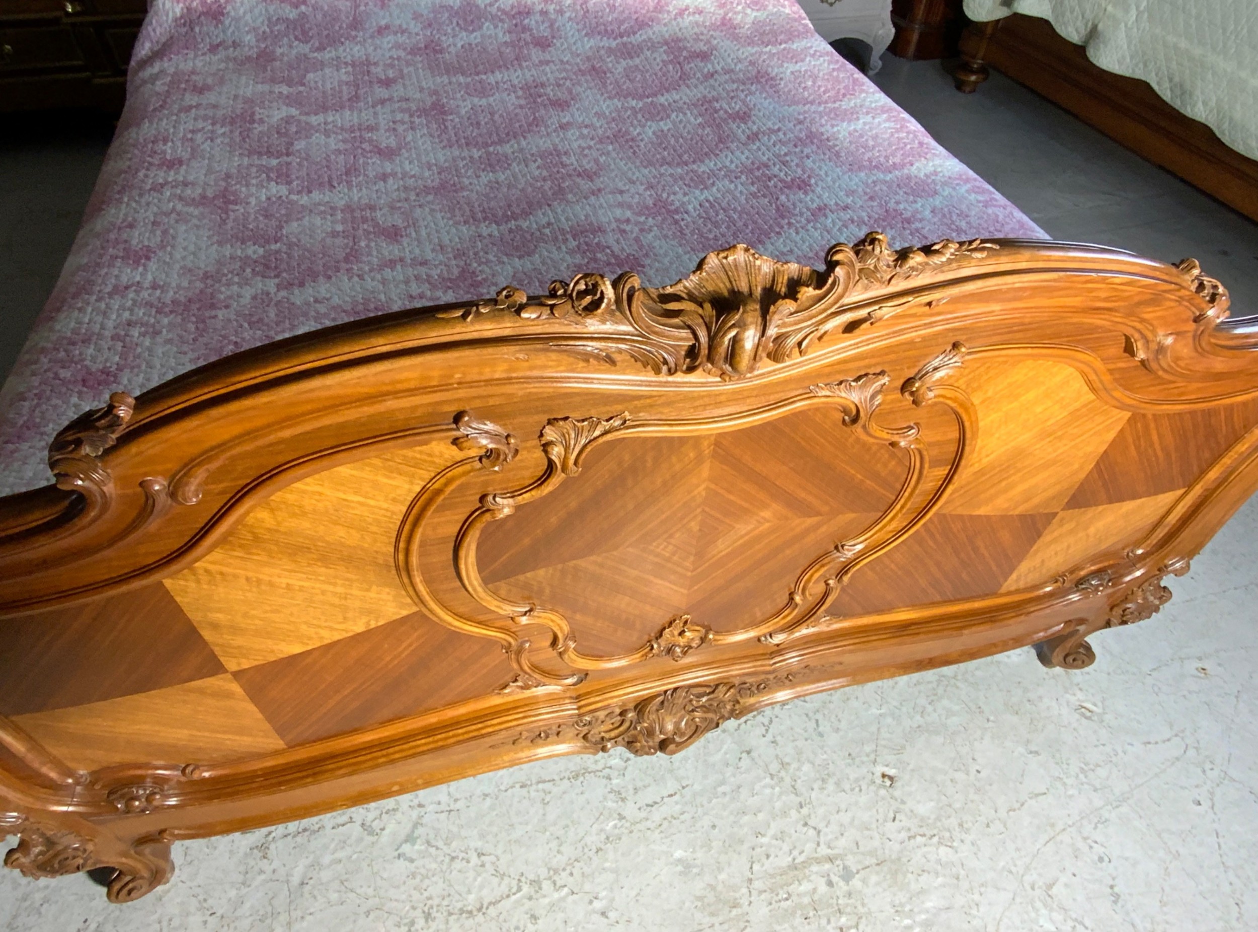 A king size French Louis XV style wooden bed frame featuring a carved crest, parquetry panelwork, and curved legs. View VII