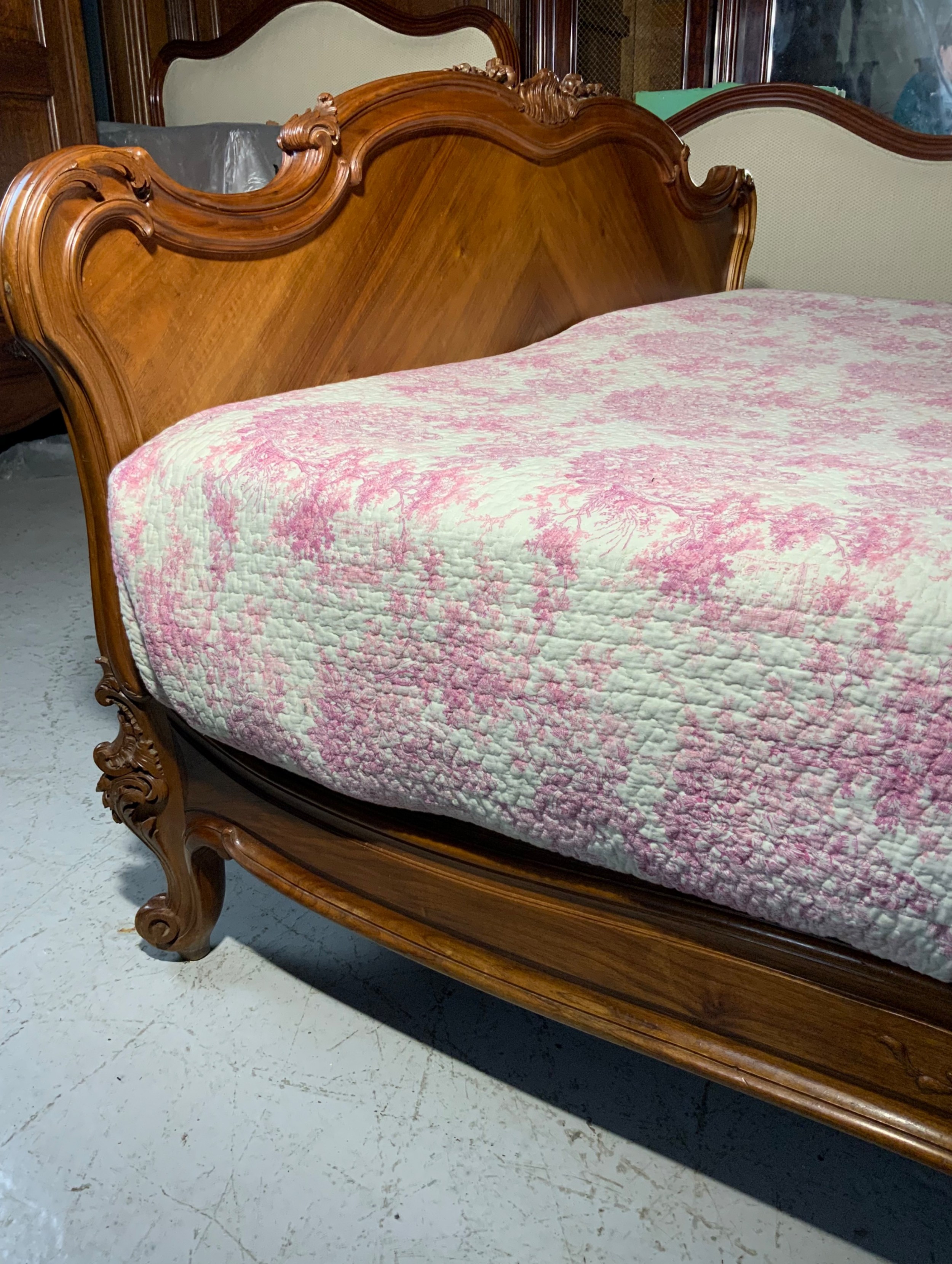 A king size French Louis XV style wooden bed frame featuring a carved crest, parquetry panelwork, and curved legs. View IX