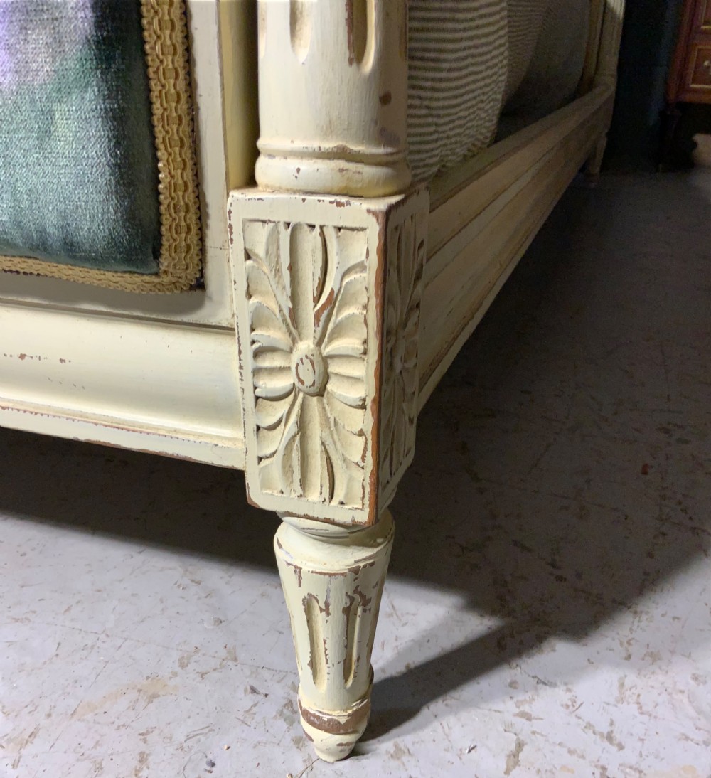 A French Louis XVI style painted bed frame with carved timber moulding and floral upholstered panels on the headboard and footboard. View IV